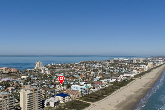 Pool deck loungers and umbrella at Athena Ares Seaside Estate, South Padre Island