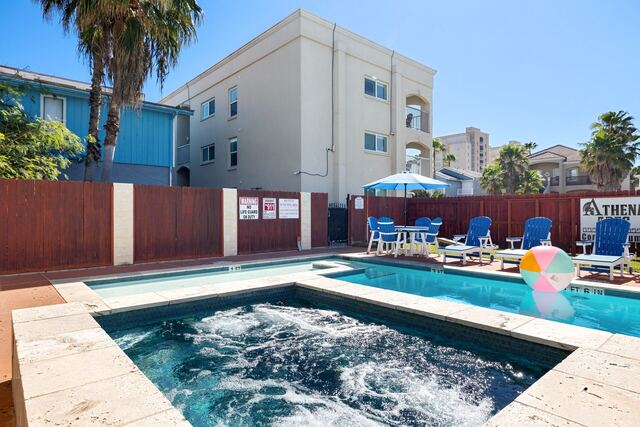 Pool deck loungers and umbrella at Athena Ares Seaside Estate, South Padre Island