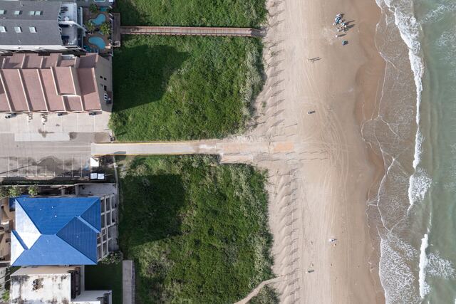 Pool with arches and palms at Athena Ares Seaside Estate, South Padre Island